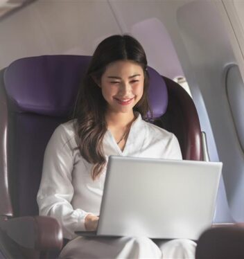 Young woman using mobile phone while sitting bus